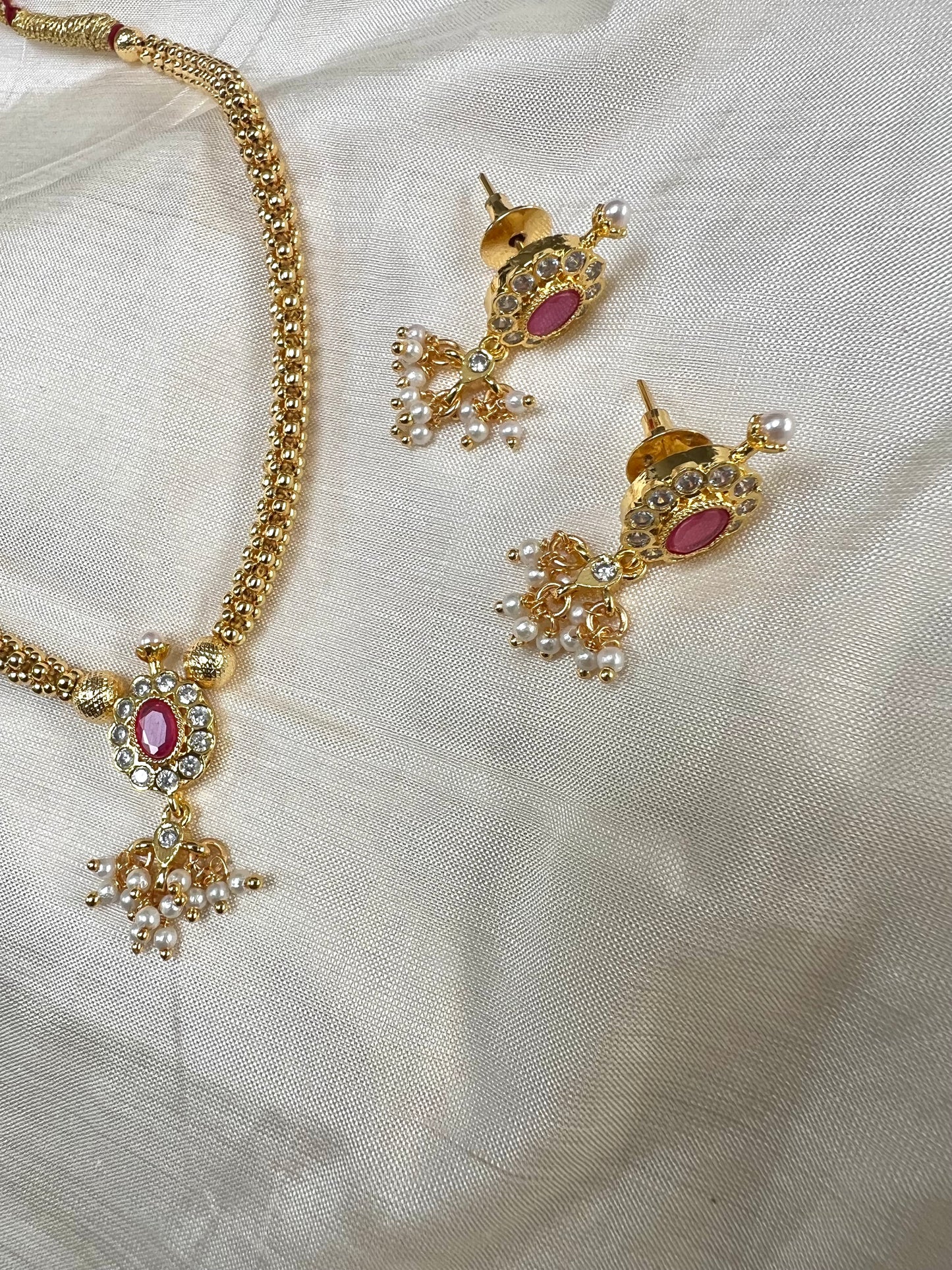 KESHANA - Simple gold chain with a white and ruby stoned centre piece with matching small earrings N3369