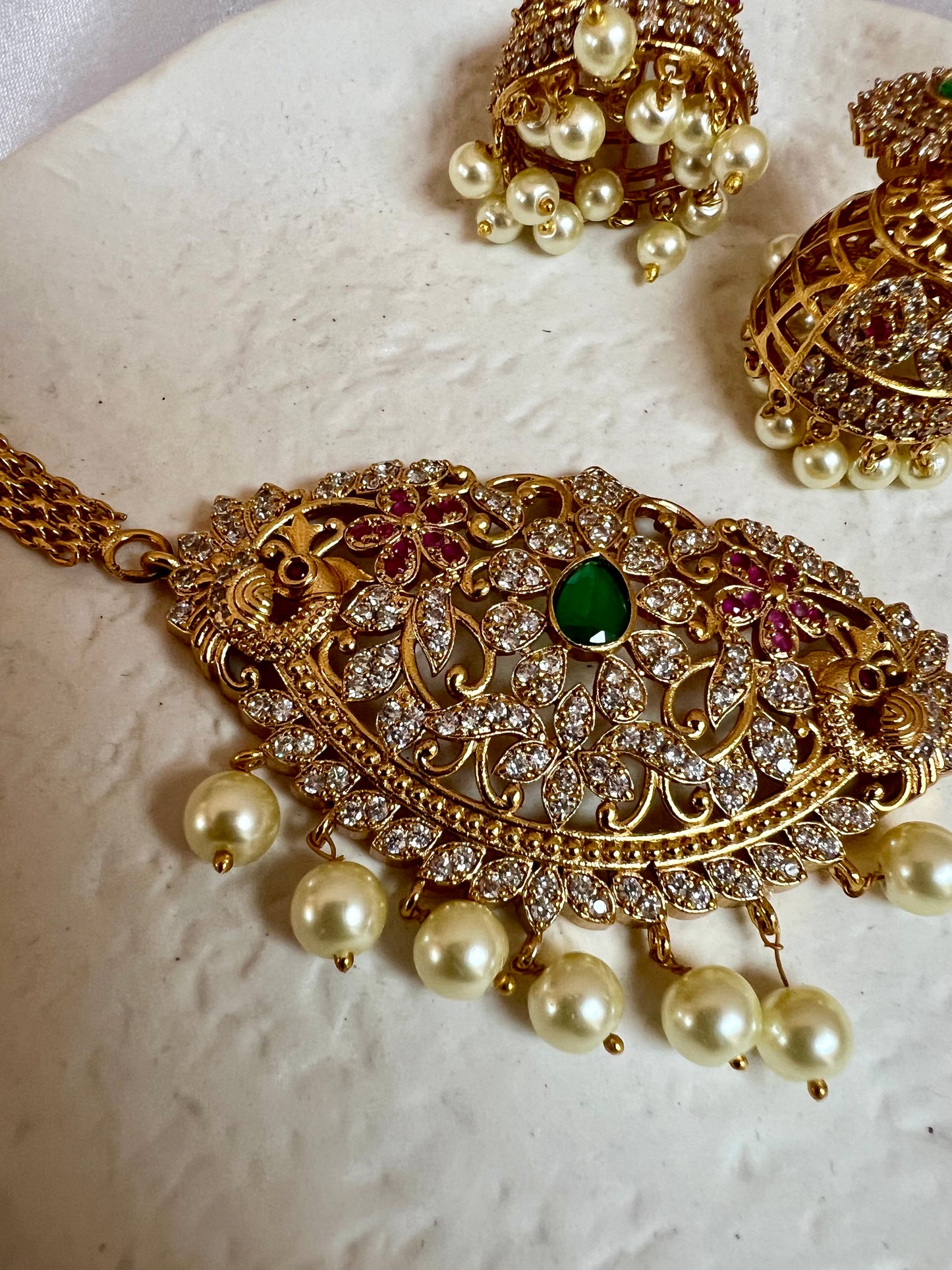 BANU- Golden oval shaped choker in ruby, green and white stones with small jhumkas N3183