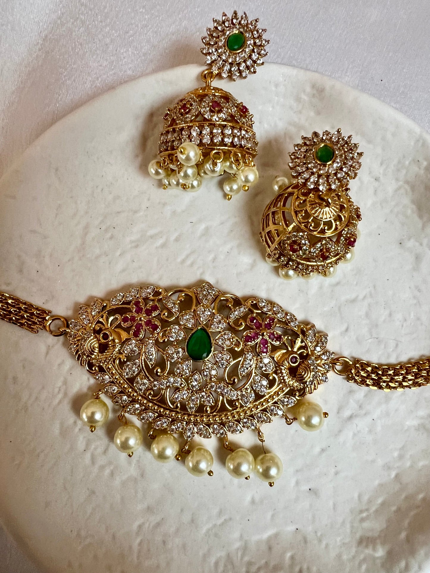 BANU- Golden oval shaped choker in ruby, green and white stones with small jhumkas N3183