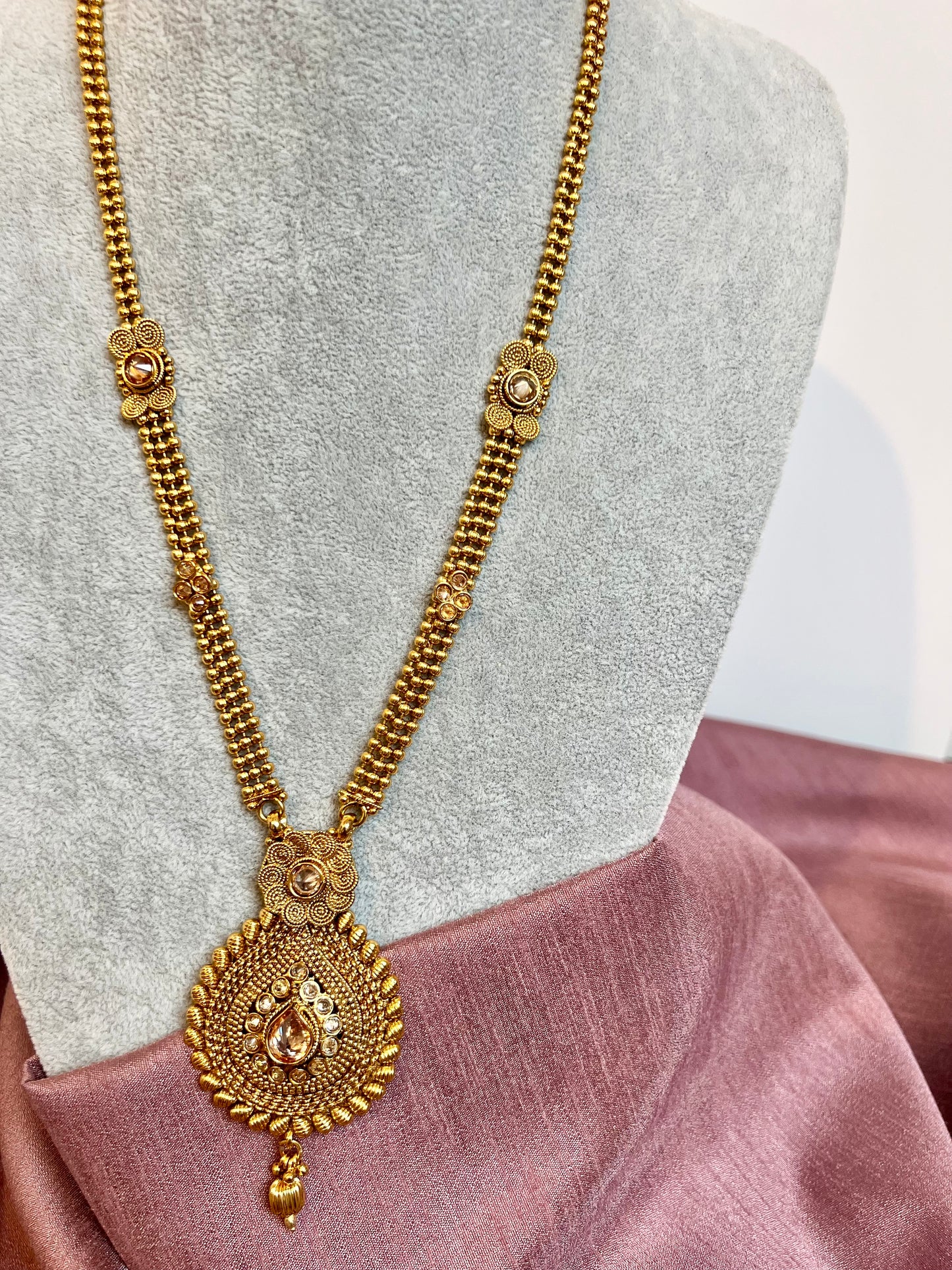 THARSHINI - long tear drop shaped pendant golden necklace with round stones N3212