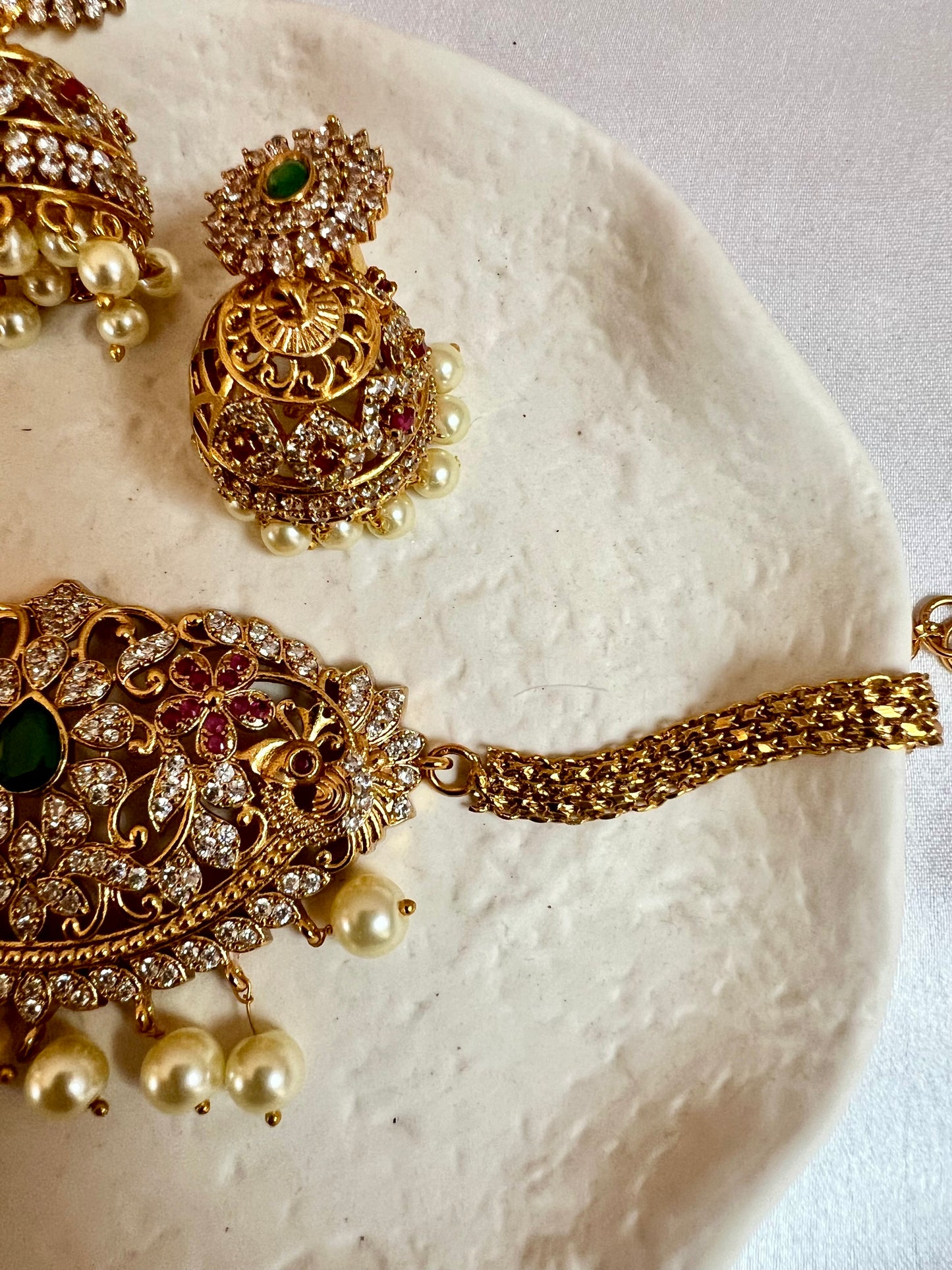 BANU- Golden oval shaped choker in ruby, green and white stones with small jhumkas N3183