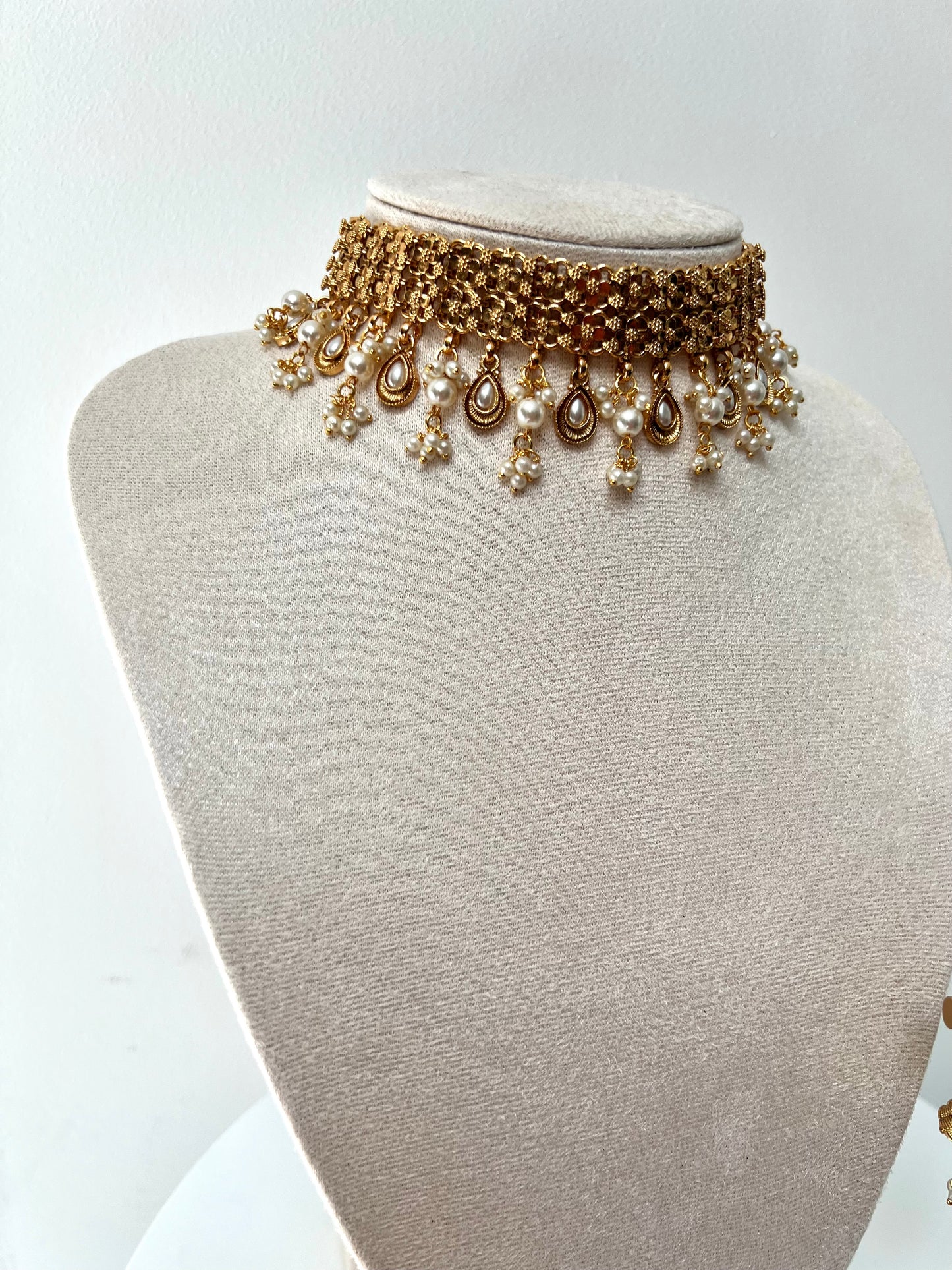 MALANI- Golden high neck band necklace embellished with dangling pearls, comes with matching small jhumkas N3296