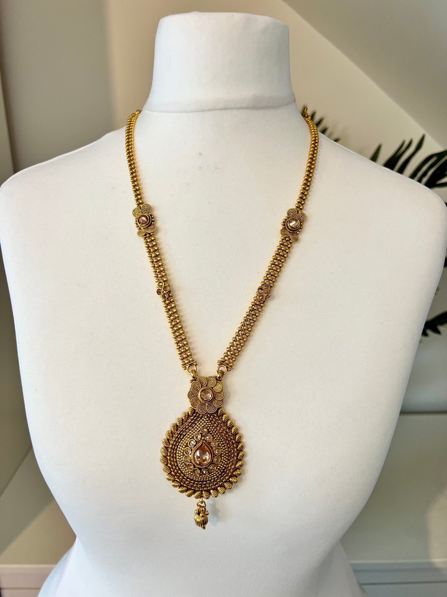 THARSHINI - long tear drop shaped pendant golden necklace with round stones N3212