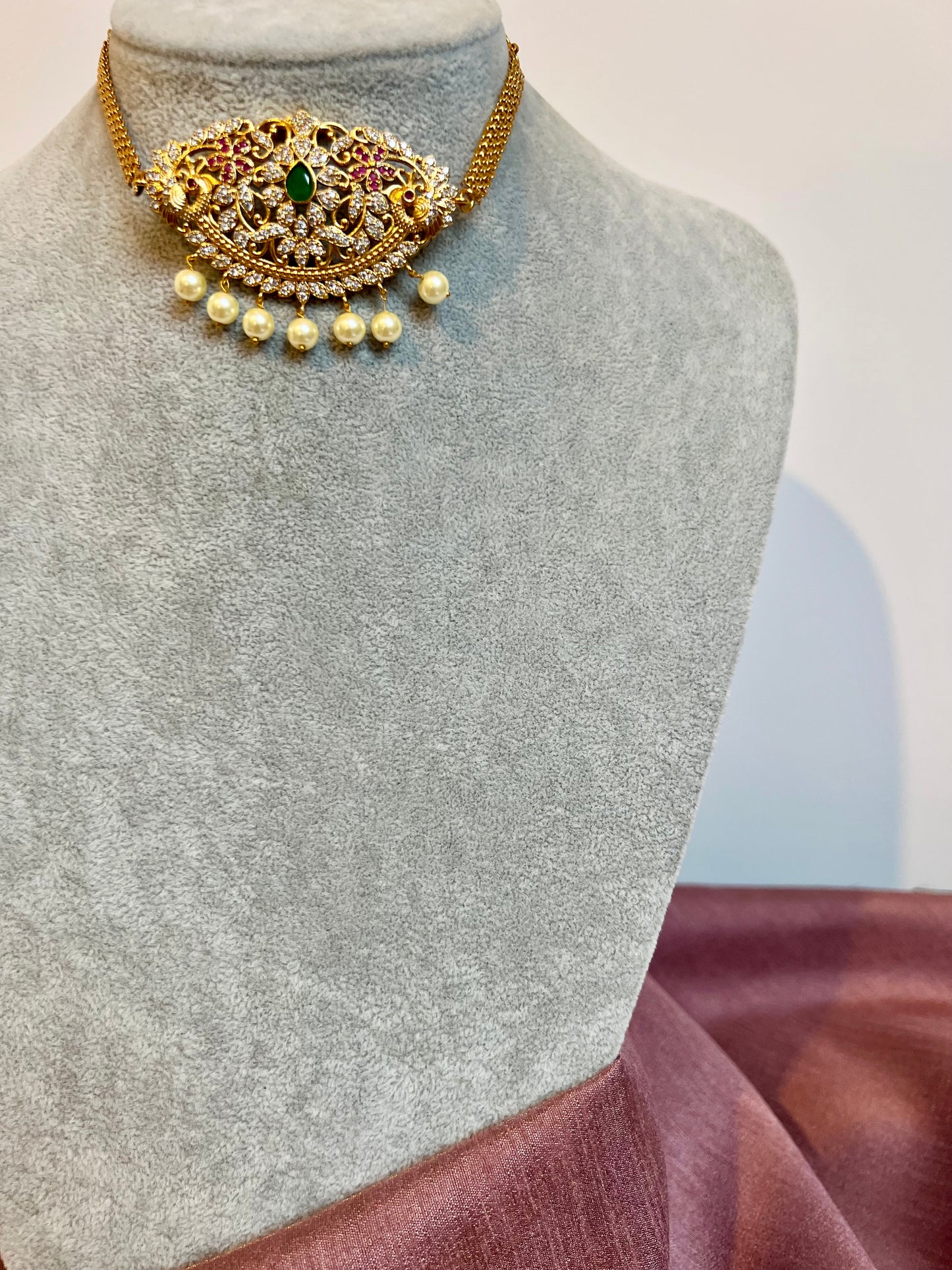 BANU- Golden oval shaped choker in ruby, green and white stones with small jhumkas N3183