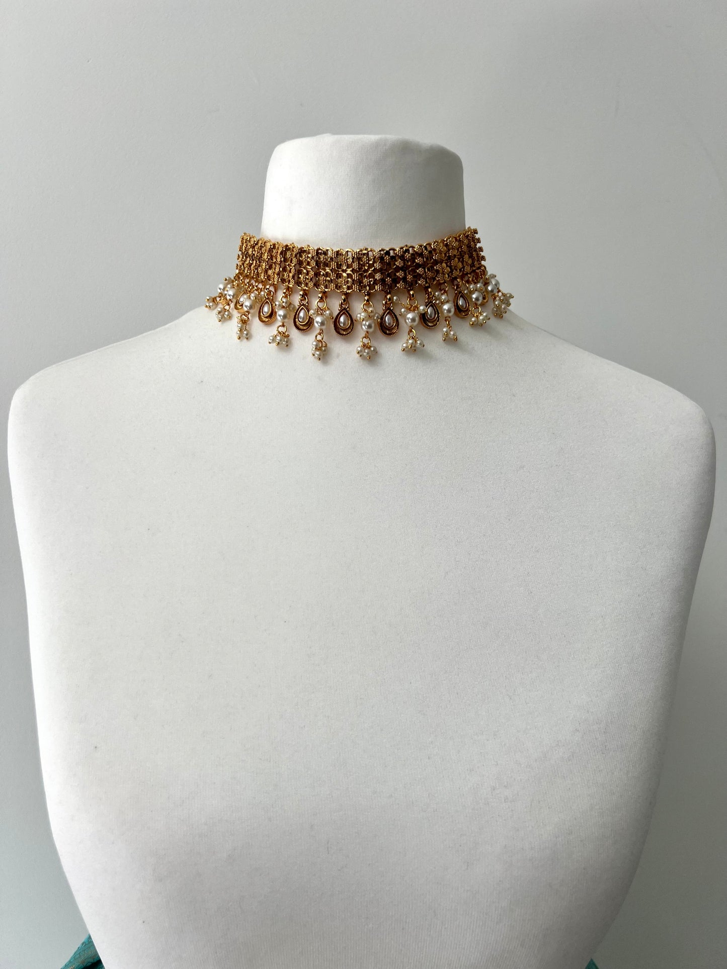 MALANI- Golden high neck band necklace embellished with dangling pearls, comes with matching small jhumkas N3296