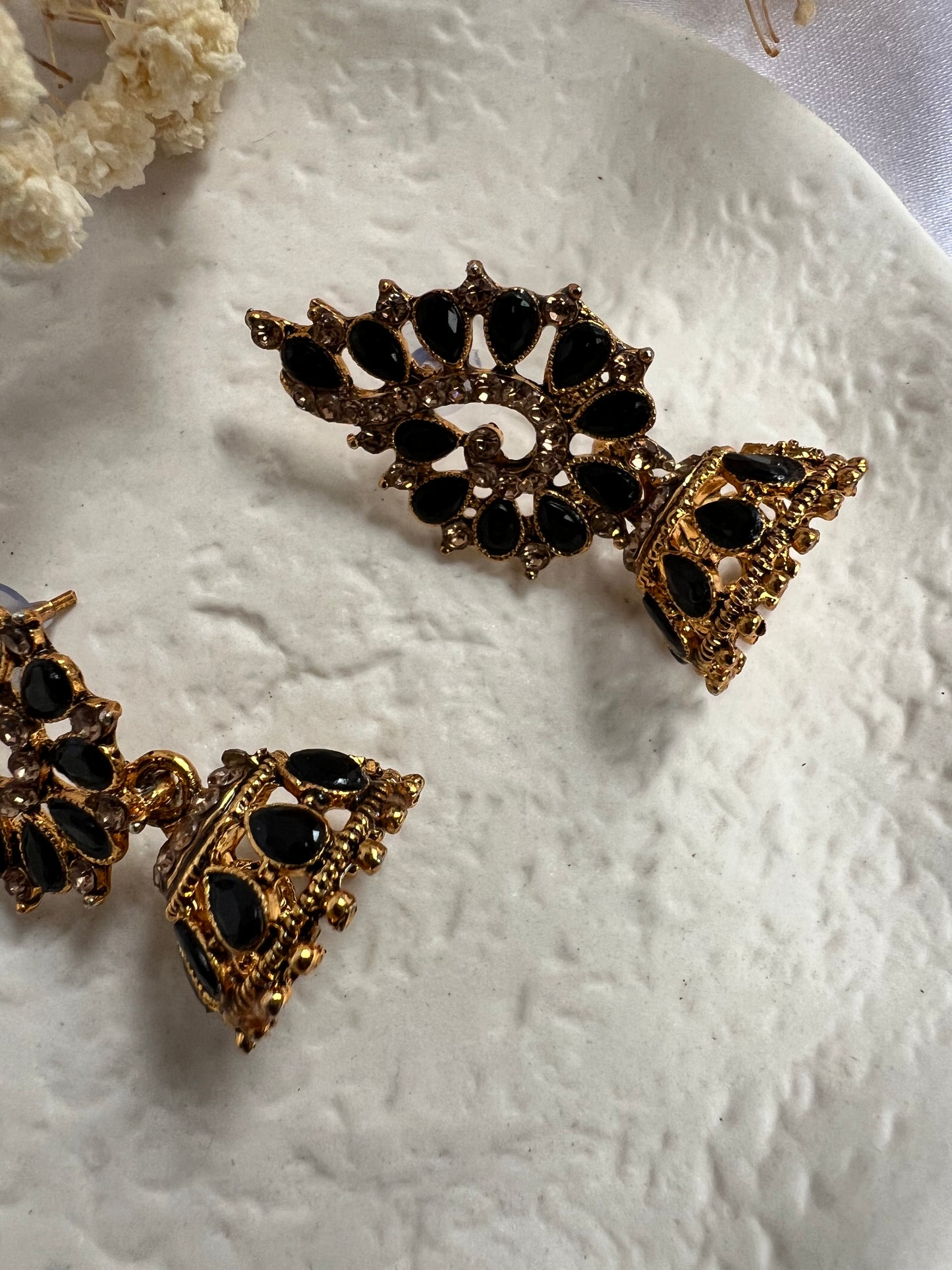 Golden stoned jhumka earrings with tear drop shaped grey stones E3050