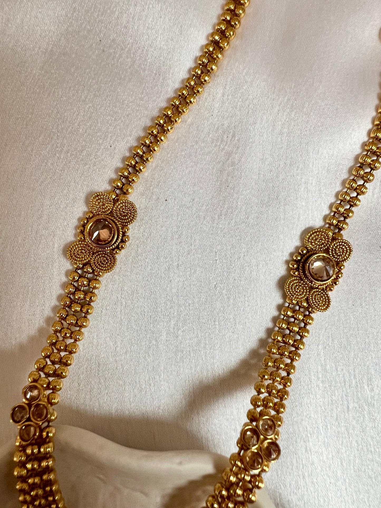 THARSHINI - long tear drop shaped pendant golden necklace with round stones N3212