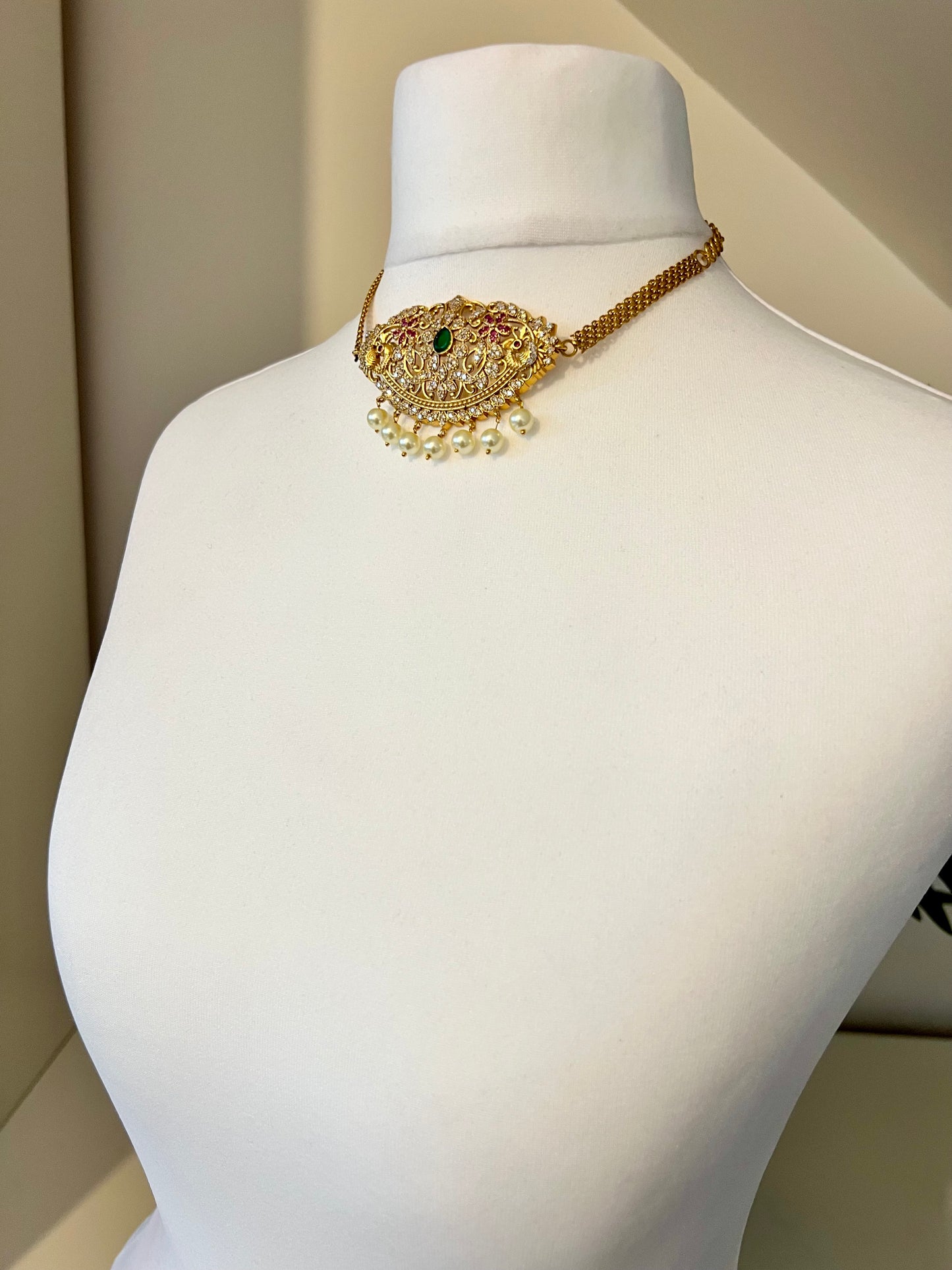 BANU- Golden oval shaped choker in ruby, green and white stones with small jhumkas N3183