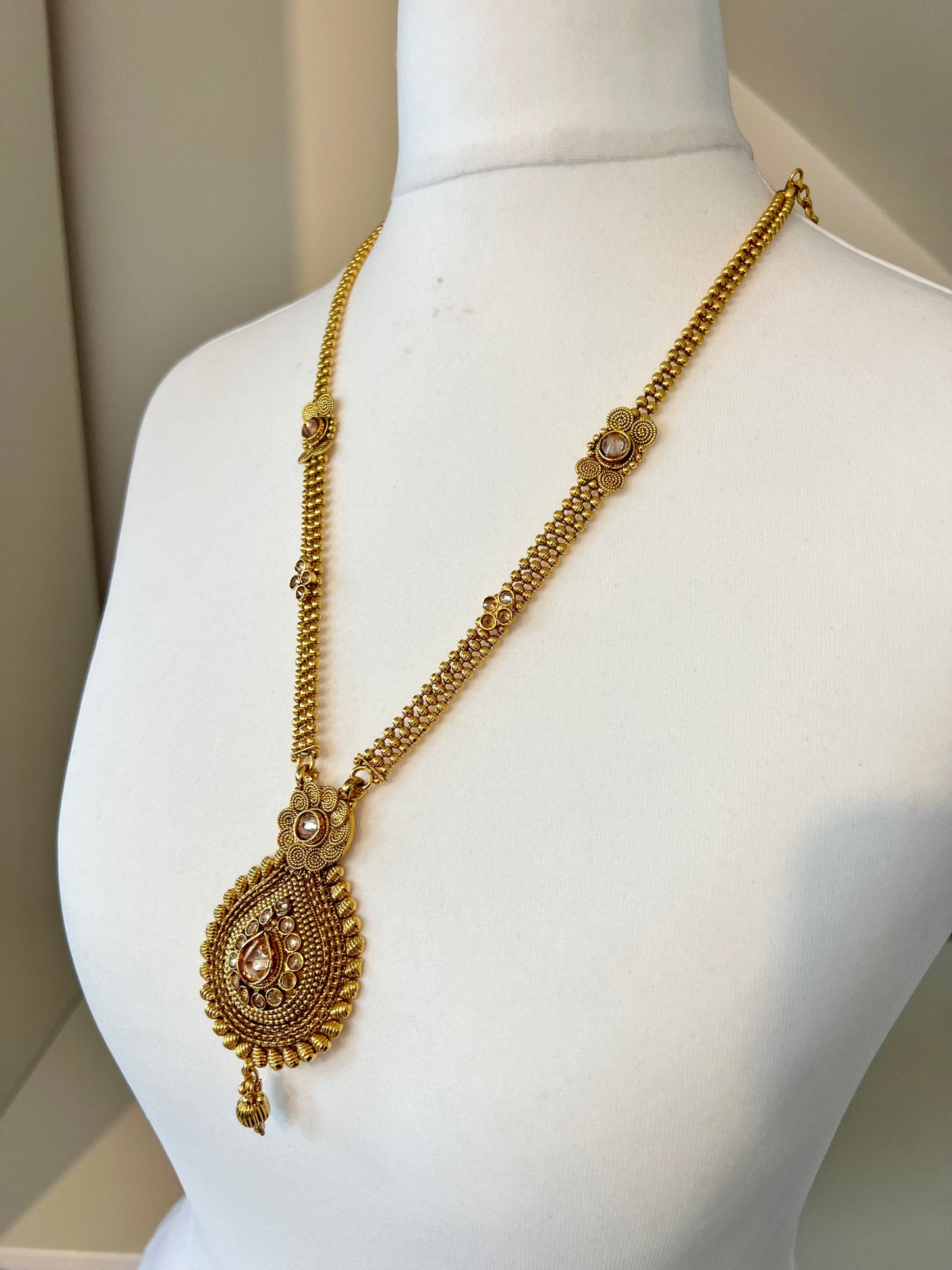 THARSHINI - long tear drop shaped pendant golden necklace with round stones N3212