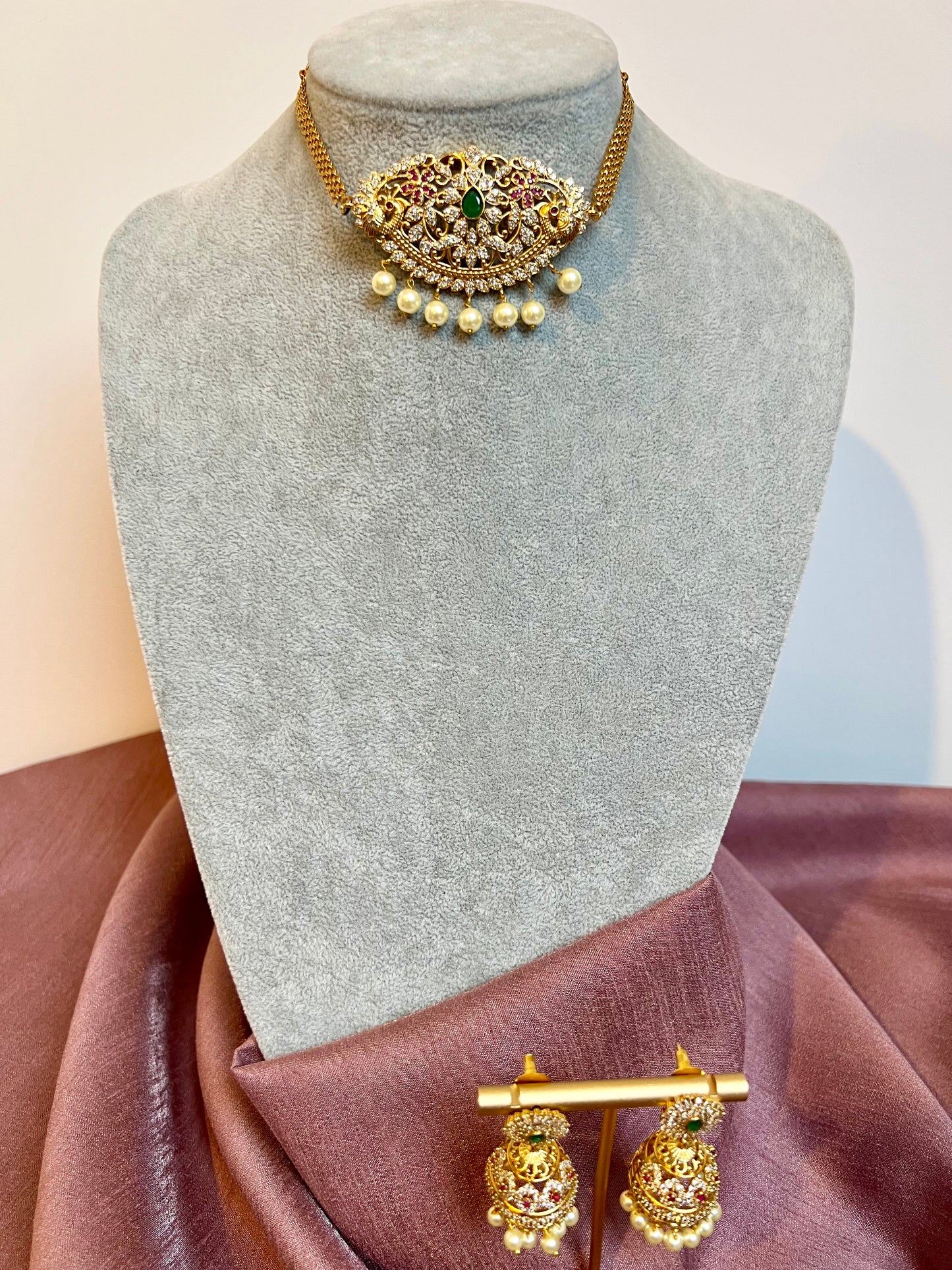 BANU- Golden oval shaped choker in ruby, green and white stones with small jhumkas N3183