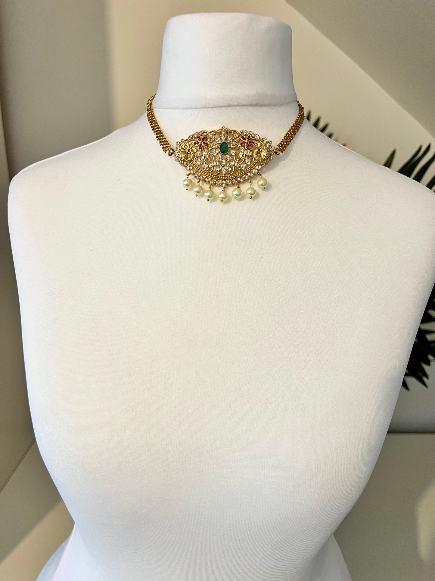 BANU- Golden oval shaped choker in ruby, green and white stones with small jhumkas N3183