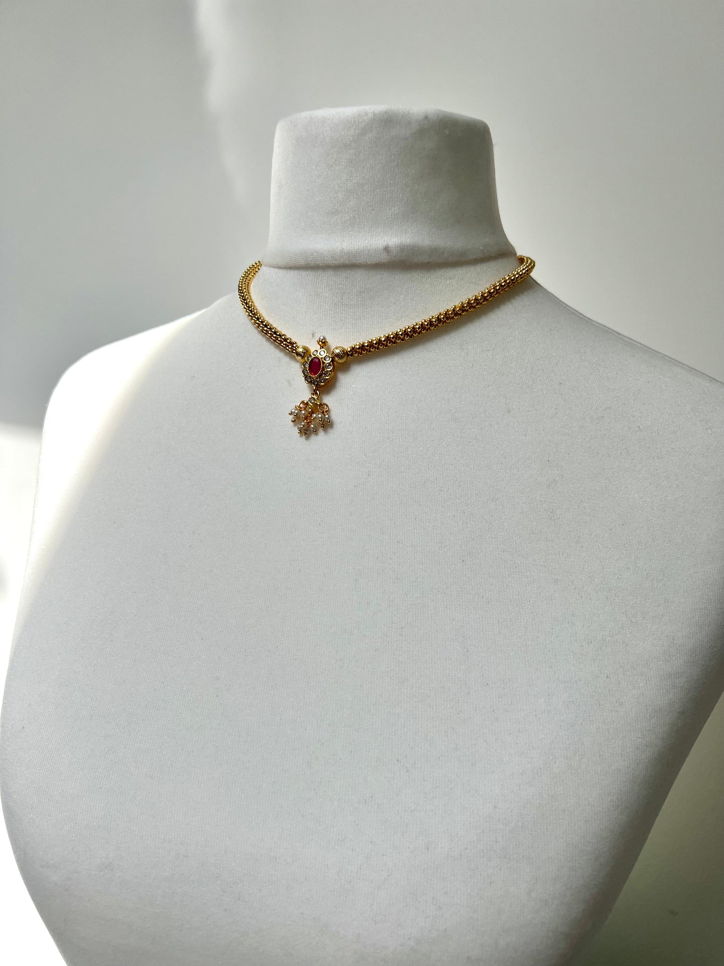 KESHANA - Simple gold chain with a white and ruby stoned centre piece with matching small earrings N3369