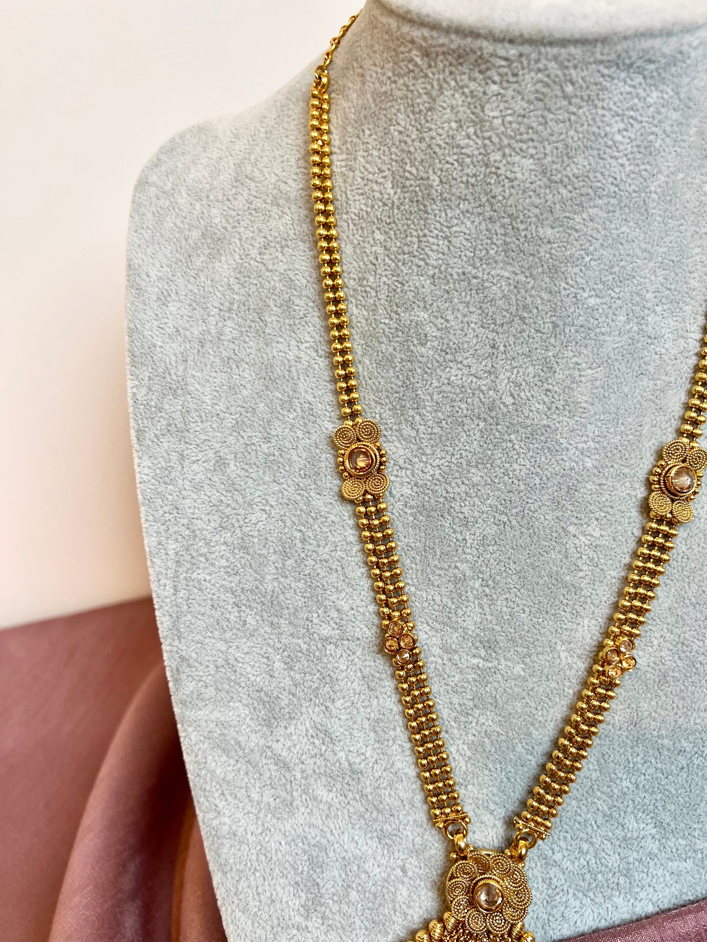 THARSHINI - long tear drop shaped pendant golden necklace with round stones N3212