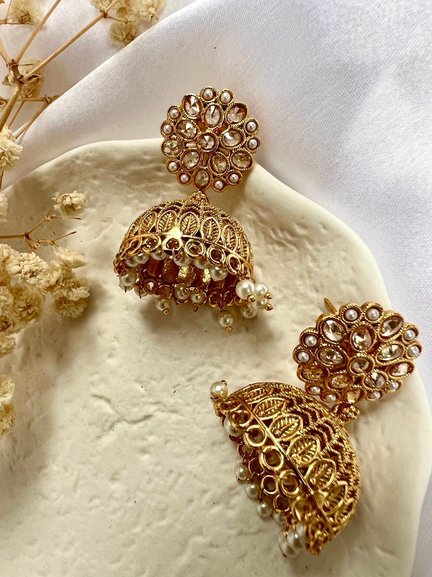 Golden jhumkas with pearls and clear stones E3034