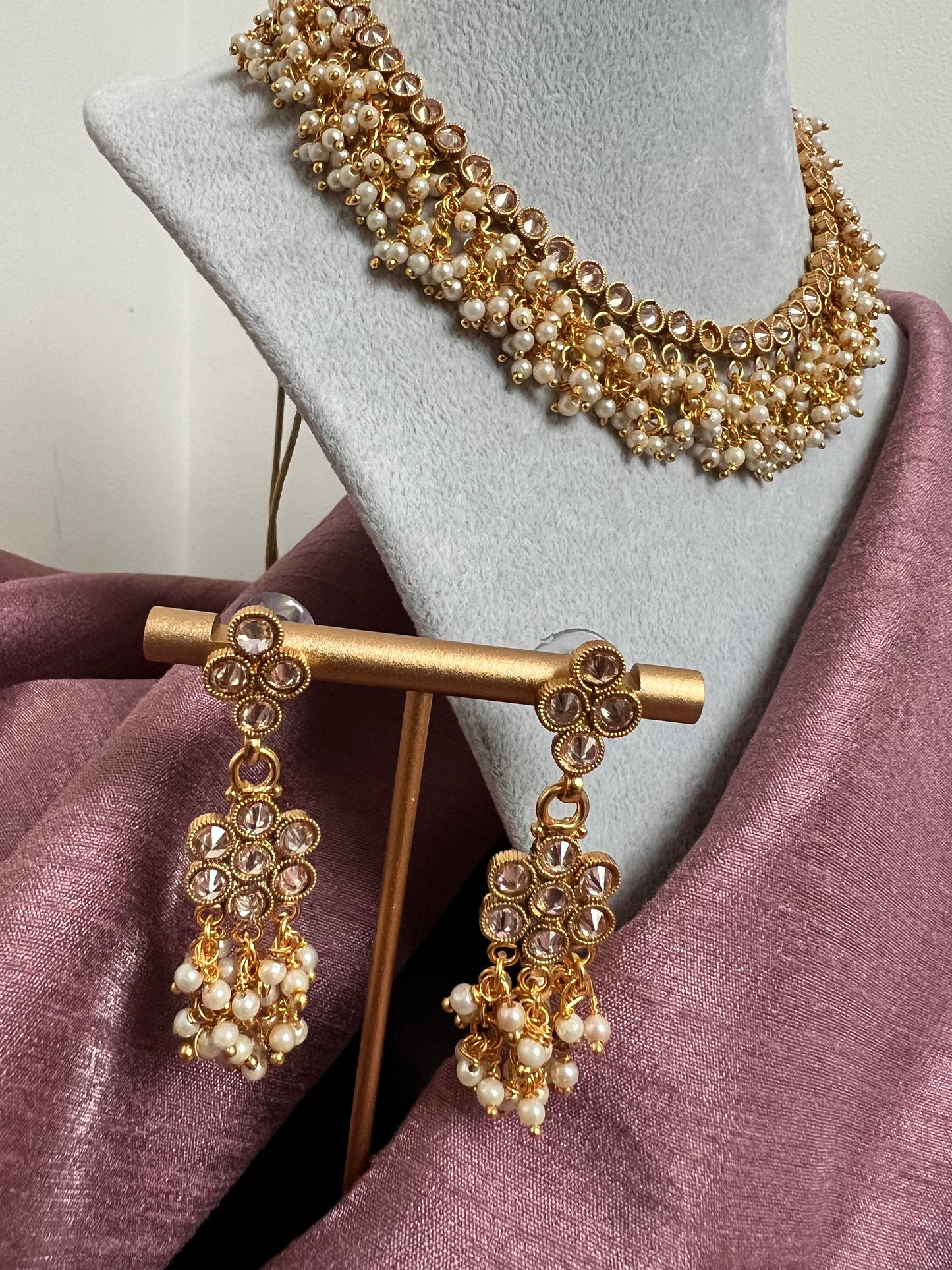 Choker necklace set with pearls and clear stones.