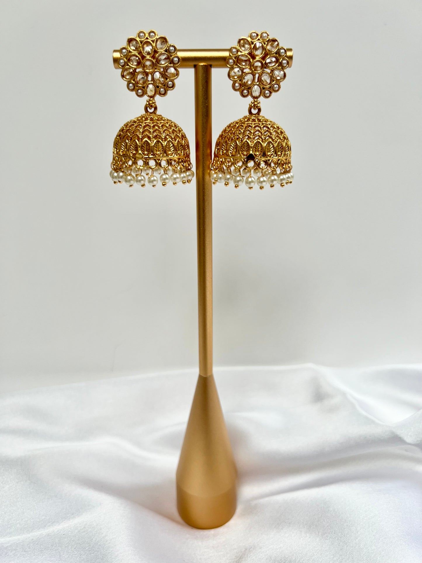 Golden jhumkas with pearls and clear stones E3034