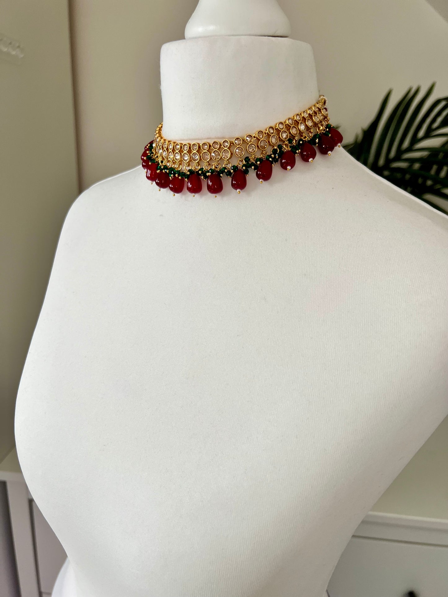 RUBIGA- Short golden necklace with small green and large maroon beads with matching jhumkas N3045