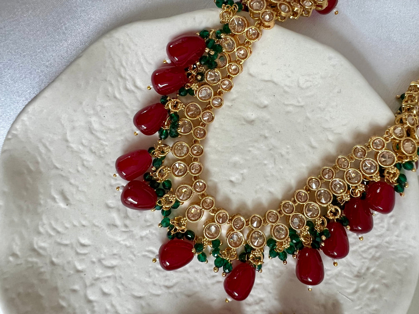 RUBIGA- Short golden necklace with small green and large maroon beads with matching jhumkas N3045