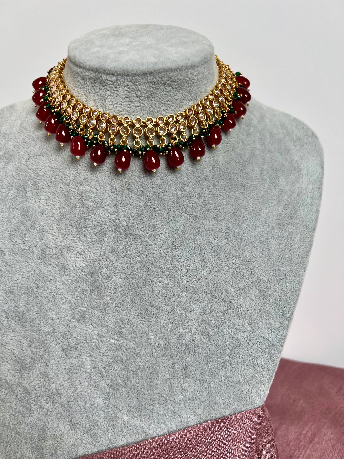 RUBIGA- Short golden necklace with small green and large maroon beads with matching jhumkas N3045