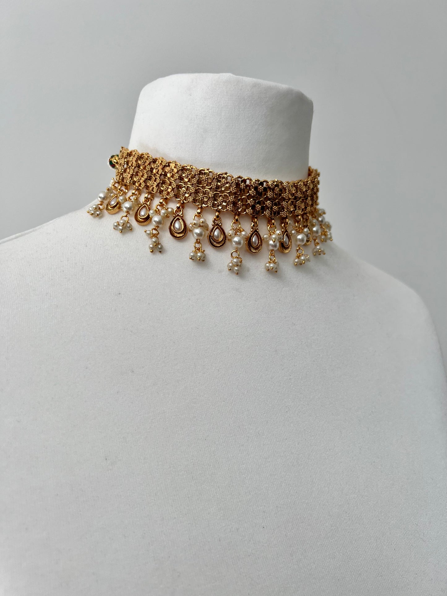 MALANI- Golden high neck band necklace embellished with dangling pearls, comes with matching small jhumkas N3296
