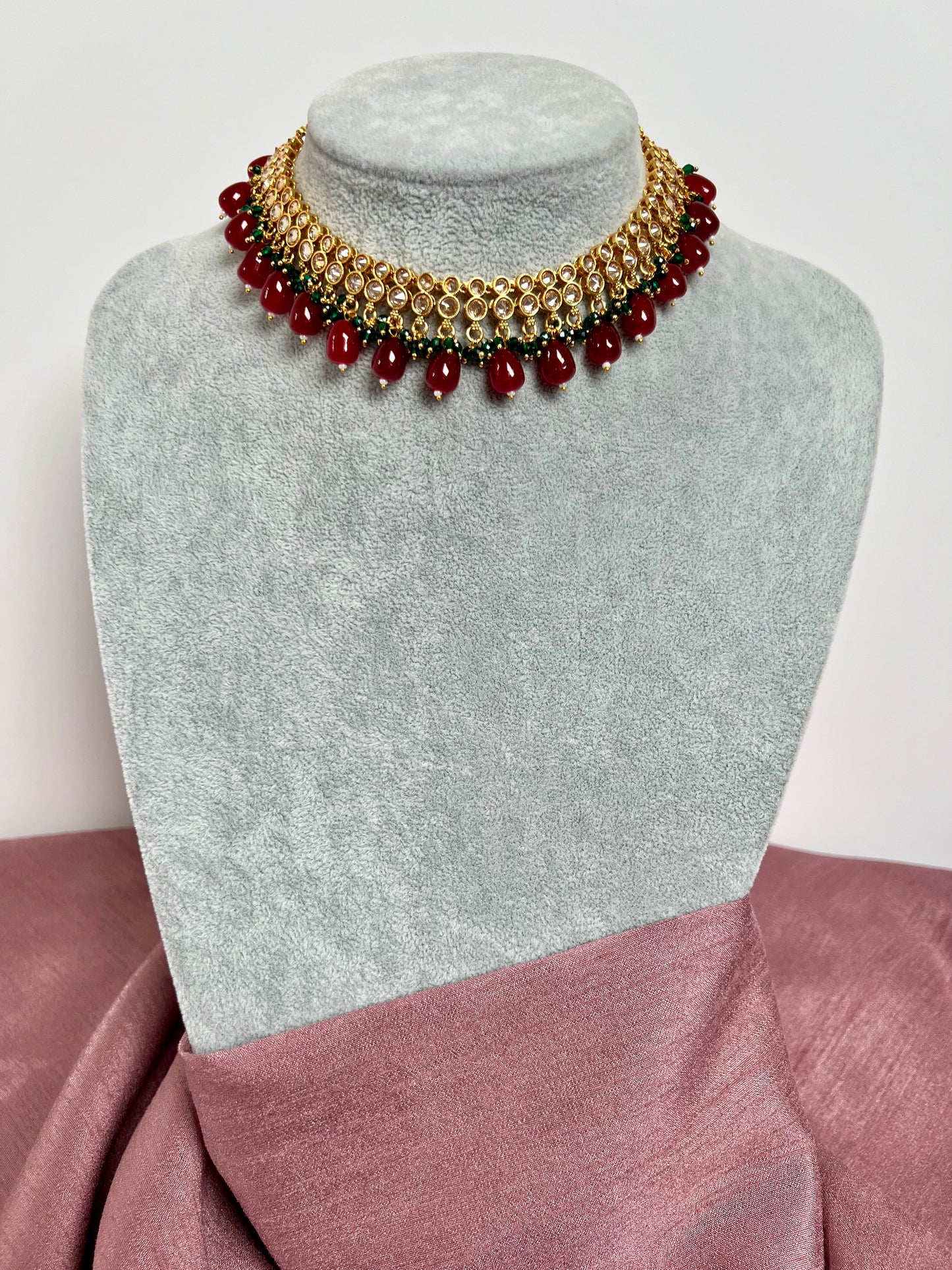 RUBIGA- Short golden necklace with small green and large maroon beads with matching jhumkas N3045