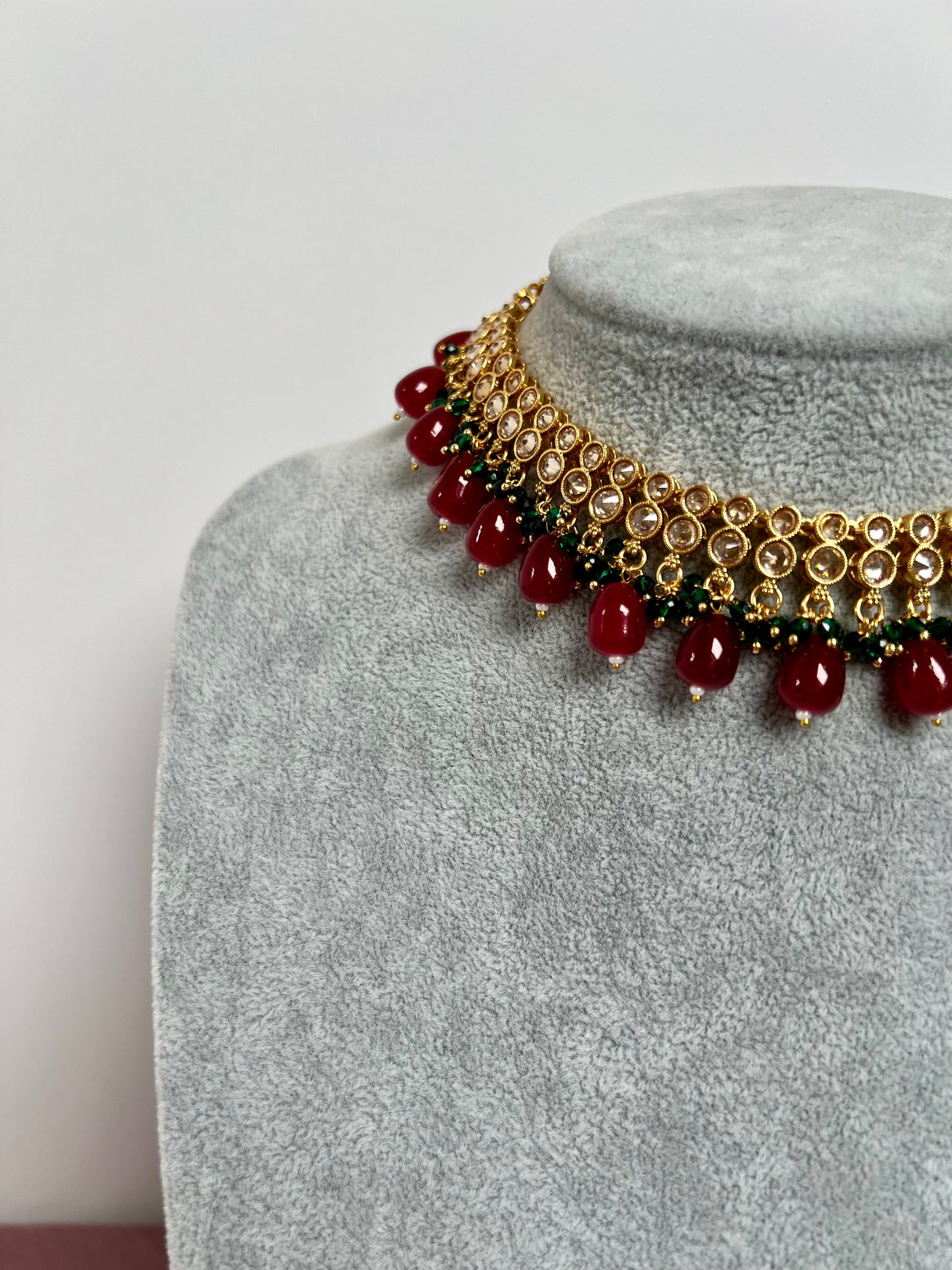 RUBIGA- Short golden necklace with small green and large maroon beads with matching jhumkas N3045