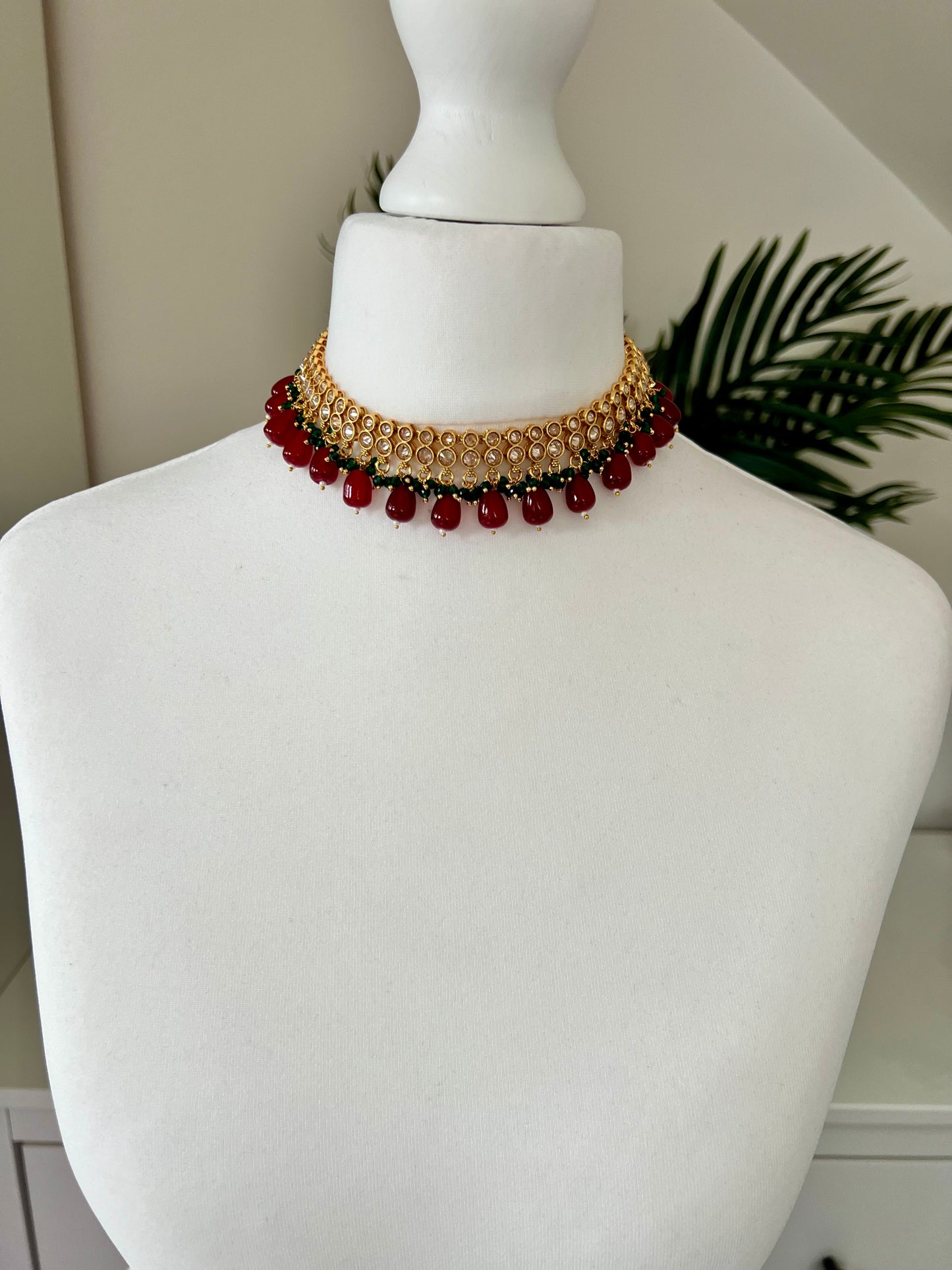 RUBIGA- Short golden necklace with small green and large maroon beads with matching jhumkas N3045