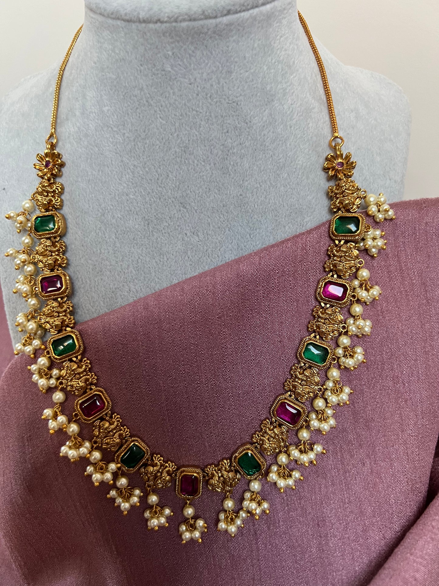 Gold plated short necklace with rubygreen stones and dangling ivory pearls with jhumka N3046